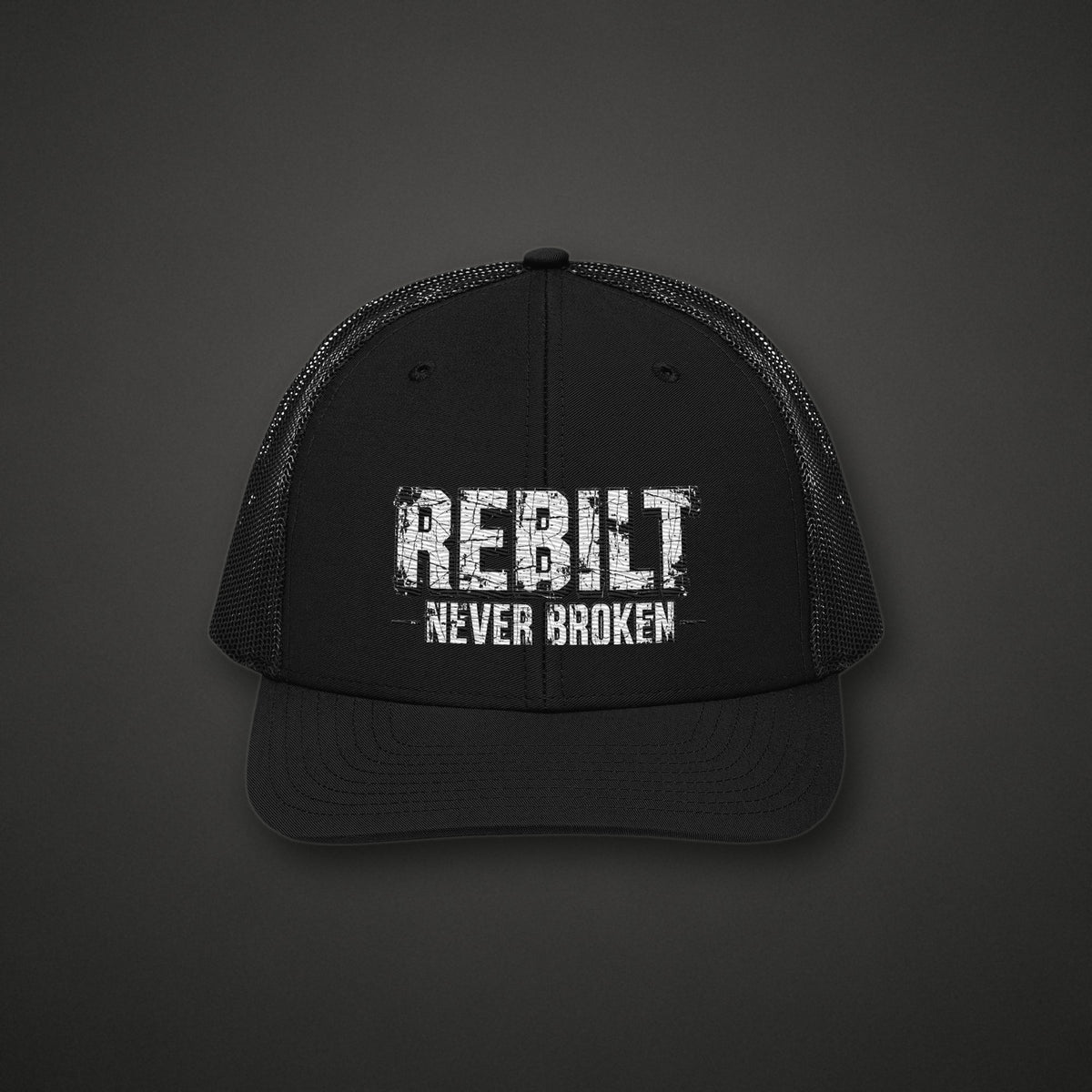 REBILT Never Broken Trucker Cap on dark background
