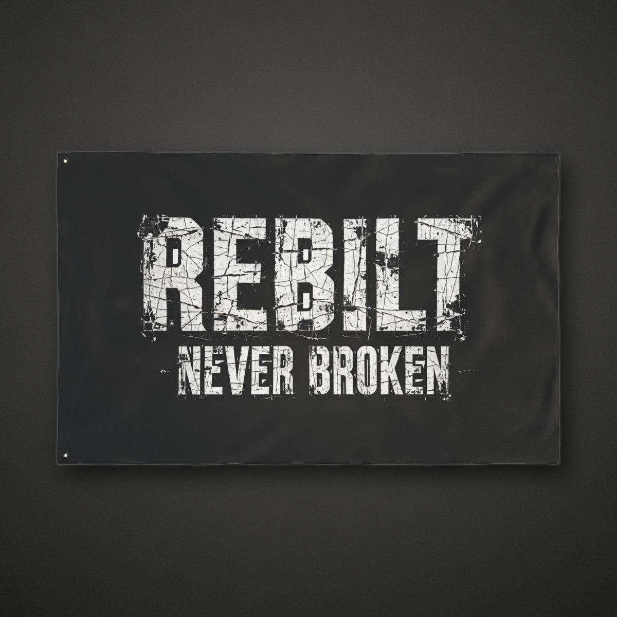 REBILT Never Broken double-sided flag on dark background