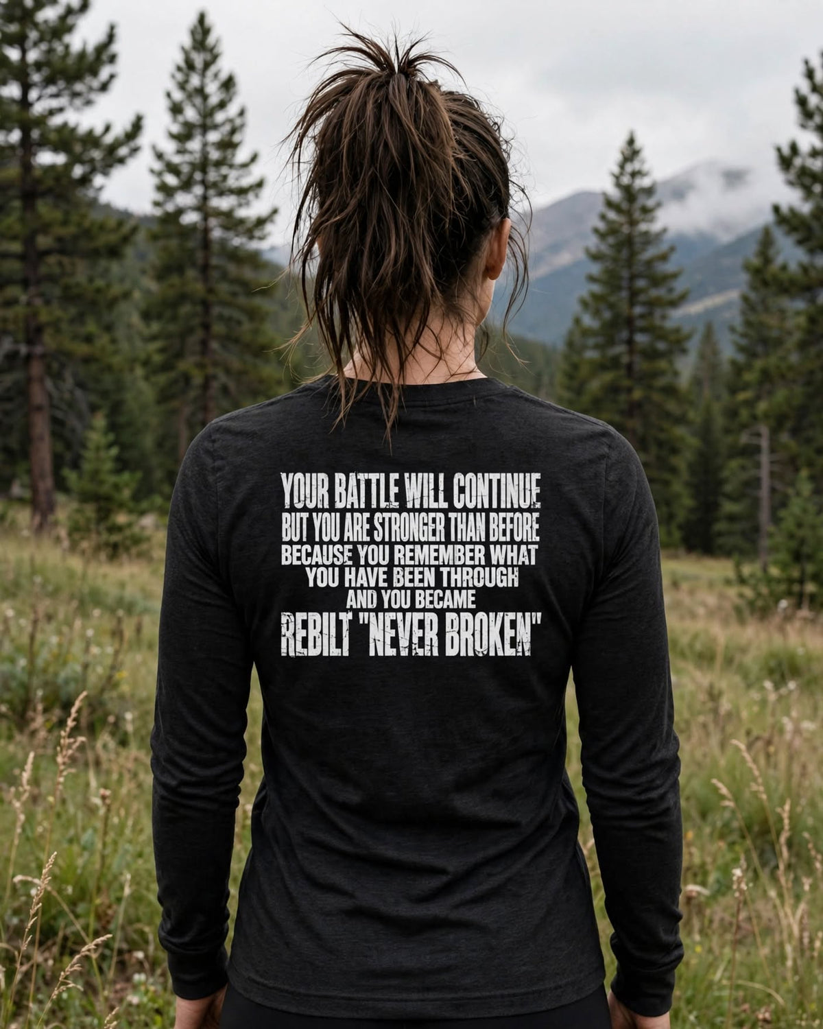 Woman wearing the REBILT Long Sleeve Tee, Your Battle Will Continue back print