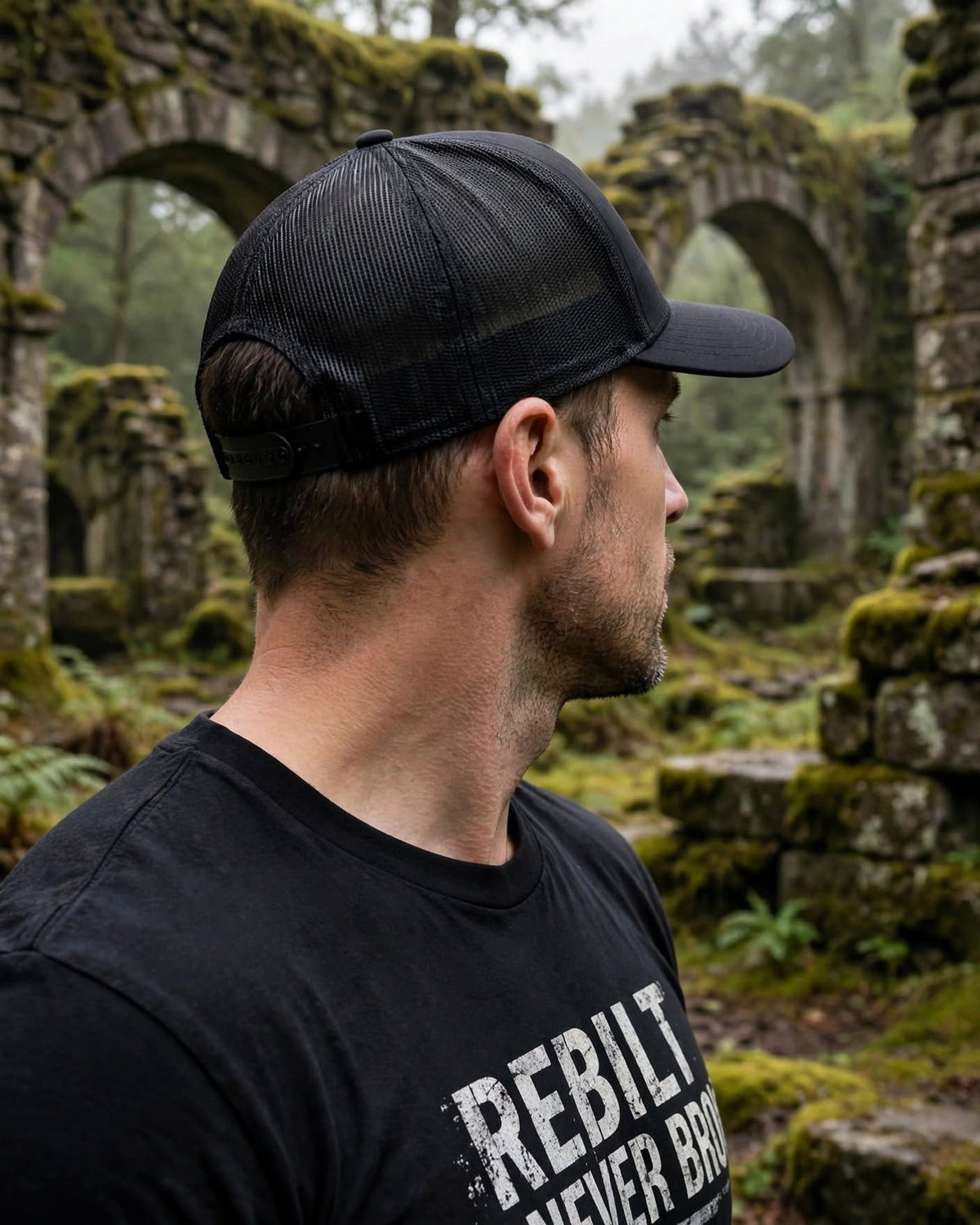 Back view of the black REBILT trucker cap showing mesh panels and plain snapback