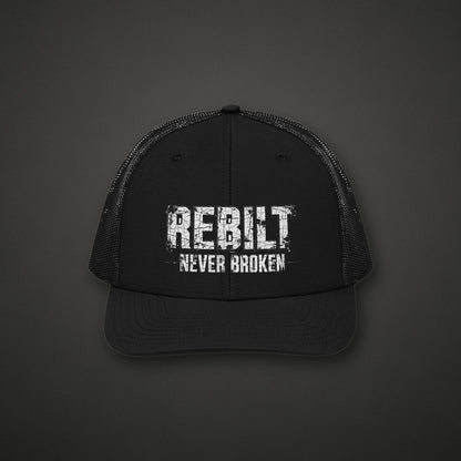 REBILT Never Broken Trucker Cap on dark background