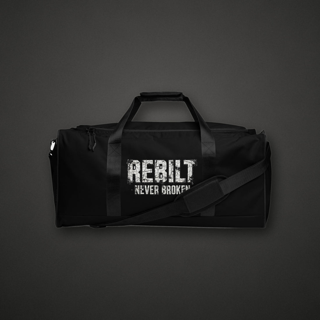 REBILT Never Broken Duffle Bag on dark background