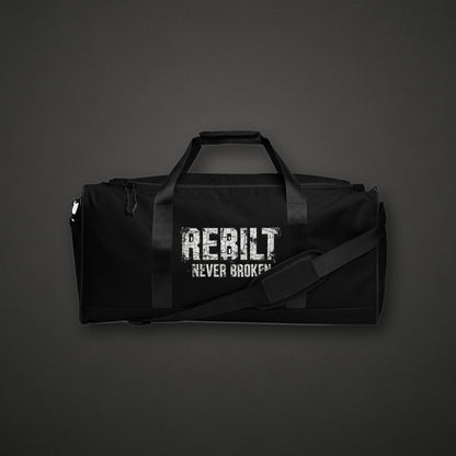 REBILT Never Broken Duffle Bag on dark background