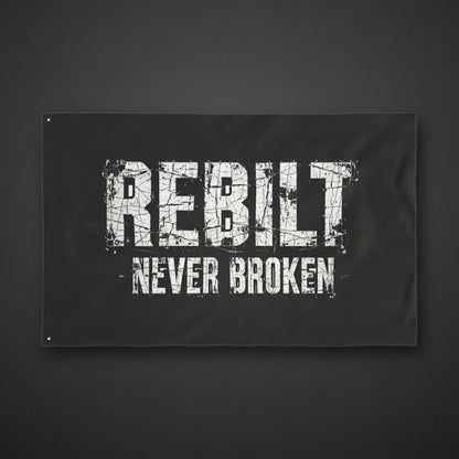 REBILT Never Broken double-sided flag on dark background