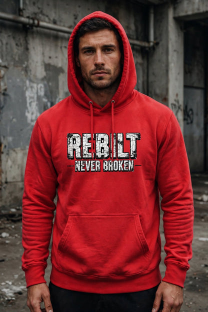 Man wearing the REBILT Never Broken Distressed Hoodie in Team Red, front logo