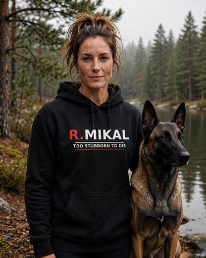 Woman wearing the R.Mikal Too Stubborn to Die Hoodie in Black with a Belgian Malinois