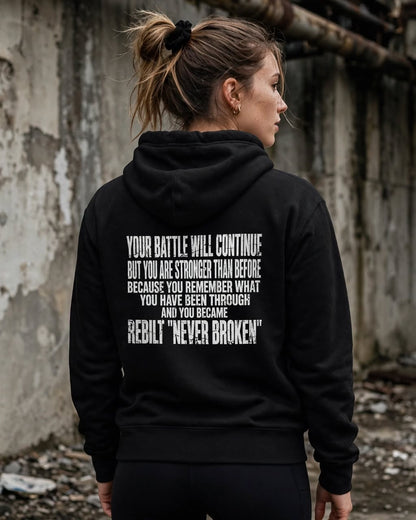 Woman wearing the REBILT Distressed Hoodie in Black, Your Battle Will Continue back print